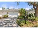 Exterior of property with two-car garage and well maintained landscaping at 905 Barclay Ct, Venice, FL 34293