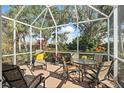 Relaxing screened lanai with comfortable seating and scenic outdoor views at 905 Barclay Ct, Venice, FL 34293