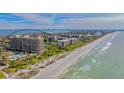 Aerial view of luxury condominiums along a pristine beach with beautiful ocean views at 1211 Gulf Of Mexico Dr # 701, Longboat Key, FL 34228