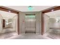 Elevator lobby with stone accent wall and carpeted corridors leading to the individual units at 1211 Gulf Of Mexico Dr # 701, Longboat Key, FL 34228