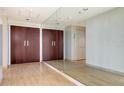Hallway featuring a large mirror, beige tile floors, and closet storage at 1211 Gulf Of Mexico Dr # 701, Longboat Key, FL 34228