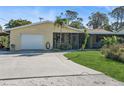 Lovely single-story home with well-kept lawn, front porch, and attached garage at 1311 Tudor Rd, Englewood, FL 34224