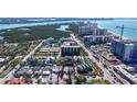 An aerial shot highlighting the property's proximity to the beach and nearby high-rise buildings at 132 Harrison Dr, Sarasota, FL 34236