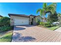 Beautiful home with brick driveway, lush landscaping, and a two-car garage, offering great curb appeal at 167 Maraviya Blvd, Nokomis, FL 34275