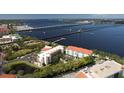 Aerial view showcases this waterfront condo, nearby marina and sparkling bay views at 210 3Rd W St # 8204, Bradenton, FL 34205