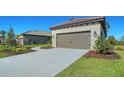 Lovely single-story home boasts a tile roof, manicured landscaping, and a two-car garage at 217 Potenza Loop, North Venice, FL 34275
