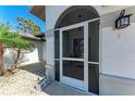 Welcoming screened front porch and a landscaped yard offer a pleasant entry to the home at 221 Fairway Rd, Rotonda West, FL 33947