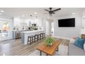 Open-concept living room and kitchen area with modern decor and stylish light fixtures at 2300 23Rd S St, St Petersburg, FL 33712