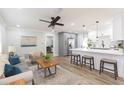 Bright, open-concept living space with a modern kitchen, stylish furnishings, and wood flooring at 2300 23Rd S St, St Petersburg, FL 33712