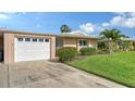 Inviting home features an attached garage, and manicured landscaping, and ample parking at 3278 Village Green Dr # 1024, Sarasota, FL 34239