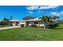 Charming single-story home boasts lush green lawn, attached garage and mature landscaping at 3278 Village Green Dr # 1024, Sarasota, FL 34239