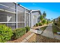 Home exterior displaying landscaping, siding, a sidewalk, and a screen enclosed patio area for outdoor relaxation at 3300 Loveland Blvd # 3203, Punta Gorda, FL 33980