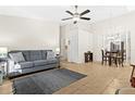 A modern living room boasts a cozy gray sofa, neutral tile floors, and an adjacent dining area at 3300 Loveland Blvd # 3203, Punta Gorda, FL 33980