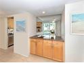 Bright kitchen with wood cabinets, granite countertops, and modern appliances at 4822 Ocean Blvd # 2D, Sarasota, FL 34242