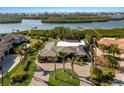 Expansive aerial view of a luxury estate with a waterfront location and manicured grounds at 525 S Shore Dr, Osprey, FL 34229