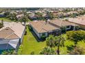 Lovely aerial view of the house with a screened lanai and well-manicured lawn at 5946 Caspian Tern Dr, Sarasota, FL 34238