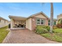 Charming single-story home featuring brick accents, lush landscaping, and a brick-paved driveway at 6140 Midnight Pass Rd # B6, Sarasota, FL 34242