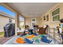 Covered patio featuring comfortable seating and a colorful rug, perfect for outdoor relaxation at 6140 Midnight Pass Rd # B6, Sarasota, FL 34242