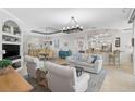 Expansive living area featuring high ceilings, an open floor plan and modern lighting, with a breakfast bar and kitchen in view at 10030 Reagan Dairy Trl, Bradenton, FL 34212