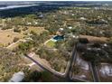 Stunning aerial view of the property showcasing lush landscaping and a beautiful lake at 1228 Wagon Wheel Dr, Sarasota, FL 34240