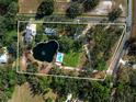 Aerial view of the property with the pond and swimming pool highlighted by a border at 1228 Wagon Wheel Dr, Sarasota, FL 34240
