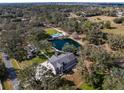 Beautiful home with a private pond and a swimming pool and patio with lounge seating at 1228 Wagon Wheel Dr, Sarasota, FL 34240