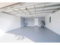 Spacious and clean garage interior with painted walls and floor, equipped with an electric water heater at 13227 Prestwick Creek Dr, Riverview, FL 33579