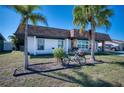 Inviting single-story home boasts a stone facade, tidy front yard, and an attached carport with driveway at 13575 Martha Ave, Port Charlotte, FL 33981