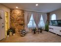 Inviting living room featuring a stone wall, recessed lighting, neutral paint and light wood floors at 13575 Martha Ave, Port Charlotte, FL 33981