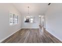 Open dining area with wood floors, neutral walls, and a view into the kitchen at 2720 60Th Avenue W Dr # D, Bradenton, FL 34207