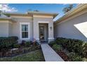 Inviting front entrance with decorative door, manicured landscaping, and a charming walkway at 2877 Sultan Ct, North Port, FL 34286