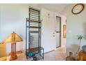 Light and bright entryway with coat rack, decor, and tiled floors at 308 Pine Run Dr, Osprey, FL 34229