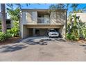 Exterior of condo features covered parking and second story balcony at 308 Pine Run Dr, Osprey, FL 34229