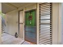 Front door adorned with a wreath, side panels, and concrete entry at 308 Pine Run Dr, Osprey, FL 34229