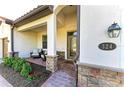 Charming front porch with stone accents, a cozy seating area, and a stylish entrance at 324 Whispering Palms Ln, Bradenton, FL 34212