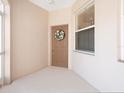 Inviting front entry features neutral tones, a decorative wreath, and a well-lit, covered entryway at 4155 Cascade Falls Dr, Sarasota, FL 34243