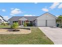 Charming home featuring a well-manicured lawn and a two-car garage at 4196 Eastlake Ct, Port Charlotte, FL 33948