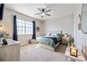 Bright bedroom featuring a ceiling fan, a large window and neutral decor at 5552 Bentgrass Dr # 7-116, Sarasota, FL 34235