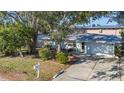 Well-maintained single-story home with landscaped front yard and attached garage at 7272 Cass Cir, Sarasota, FL 34231