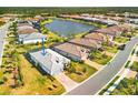 Beautiful aerial view of the home and community featuring lake views and landscaping at 7311 Summerland Cv, Bradenton, FL 34202