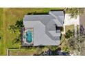 Aerial view of house with screen enclosed pool and spa, lush landscaping and private backyard at 1314 Brambling Ct, Bradenton, FL 34212