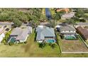 Aerial view of home showing pool, landscaping, and proximity to canal and neighboring properties at 1314 Brambling Ct, Bradenton, FL 34212