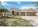 Charming single-story home featuring a three-car garage, manicured lawn and inviting curb appeal at 1314 Brambling Ct, Bradenton, FL 34212