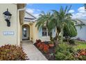 Inviting front entrance with a concrete walkway, attractive landscaping, and a view of the front door at 1407 Morning Sky Gln, Bradenton, FL 34208