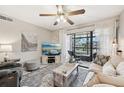 Inviting living room with neutral colors and a sliding door to the screened in lanai at 1515 Forrest Nelson Blvd # Q205, Port Charlotte, FL 33952