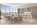 Contemporary kitchen with sleek cabinetry, island seating, and stunning city view at 1703 Main St # Ph 3, Sarasota, FL 34236