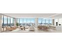 Bright, open-concept living space with floor-to-ceiling windows offering panoramic city views at 1703 Main St # Ph 3, Sarasota, FL 34236