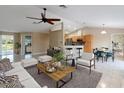 Spacious open-concept living room featuring tile flooring, modern decor, and natural light at 222 Pine Glen Ct, Englewood, FL 34223