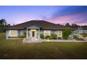 Charming single-story home with manicured lawn, stone accents, covered entry and paver walkway at 25605 69Th E Ave, Myakka City, FL 34251