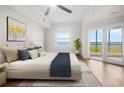 Bright main bedroom with hardwood floors, king bed and an adjoining balcony with water views at 2825 Terra Ceia Bay Blvd # 1505, Palmetto, FL 34221